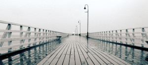 an ocean pier on a gray morning